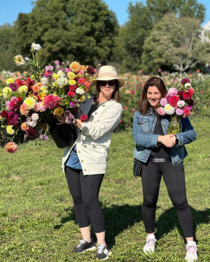 customers with vase and bucket of flowers at Grateful Gardeners